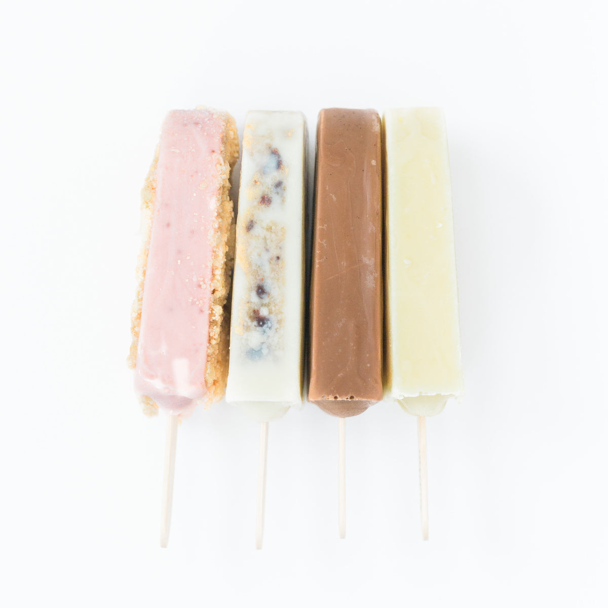 joy pops on a white background orange cream fudgsicle strawberry shortcake and milk and cookies pops