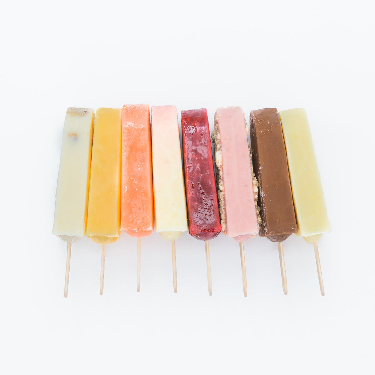 8 joy pop ice pops laying side by side next to each other on a white background